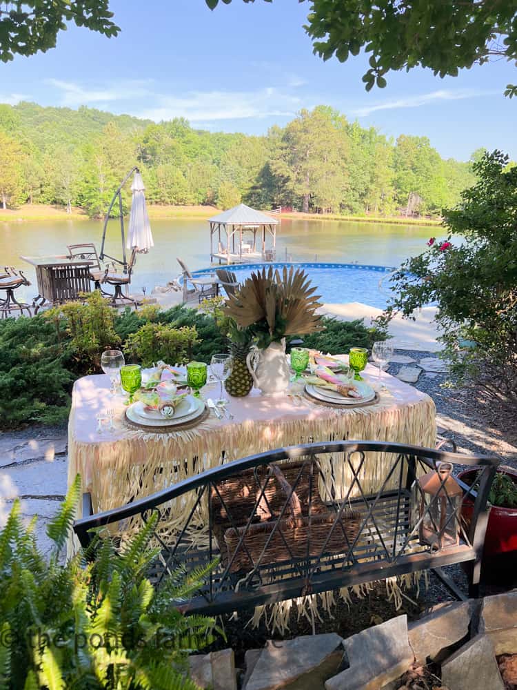 Luau Party alfresco dining next to the pool with budget luau table ideas for alfresco dining.