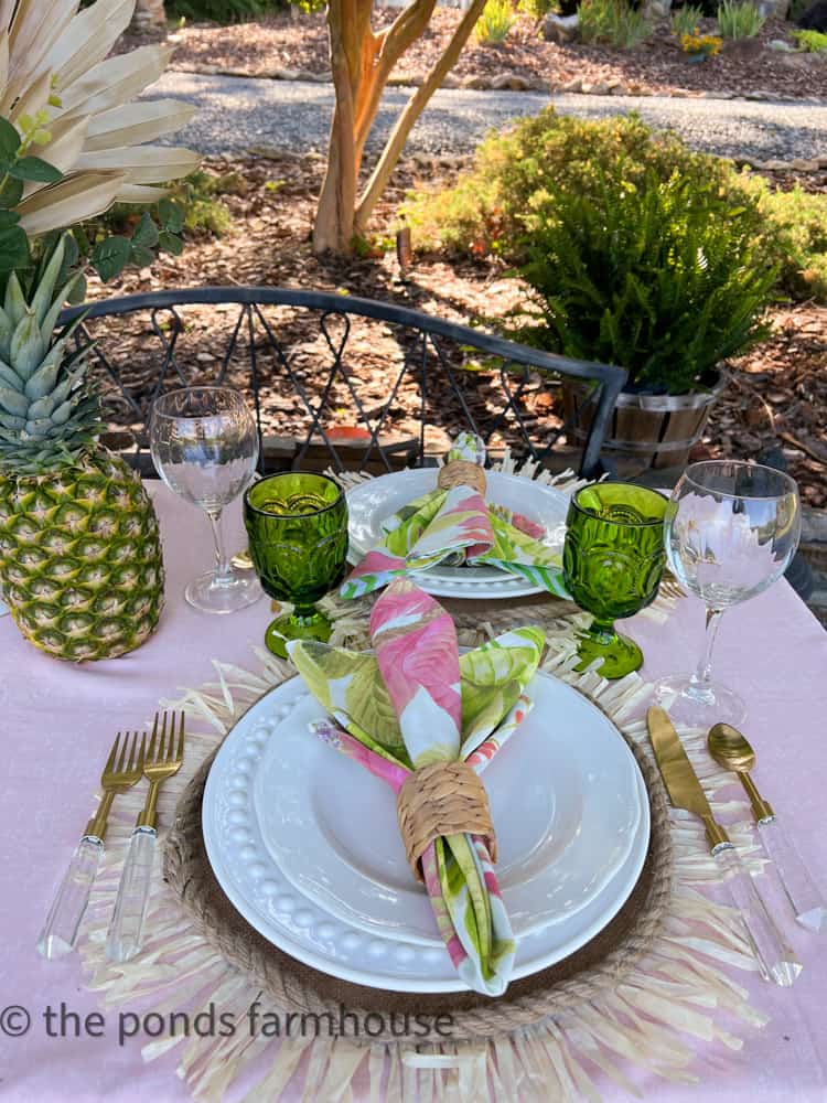 Tulip Napkin fold looks great on white plates with gold and acrylic flatware for budget Luau table decor idea