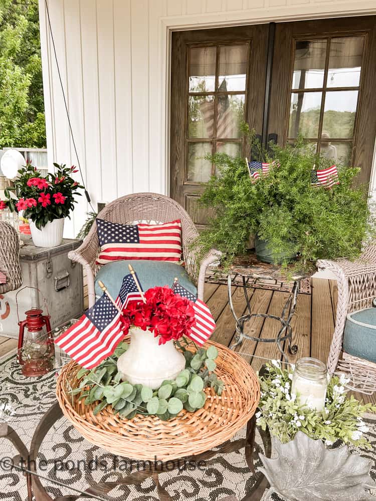 Patriotic porch - add flags to floral arrangements. Outdoor wicker chairs.  Outdoor rugs.