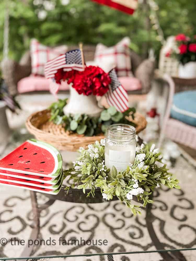 candle and candle ring on coffee table. Iron and glass coffee table. Outdoor porch rug.