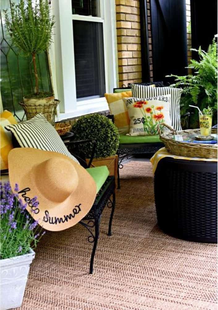 French Porch decor. Dress up porch chairs with pillows. Porch rugs. Outdoor plants on front porch.