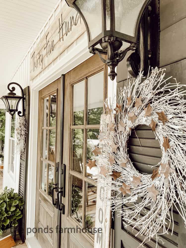 Neutral star wreath on shutter for Summer Wreath Ideas.  Upcycle aluminum cans for stars.  