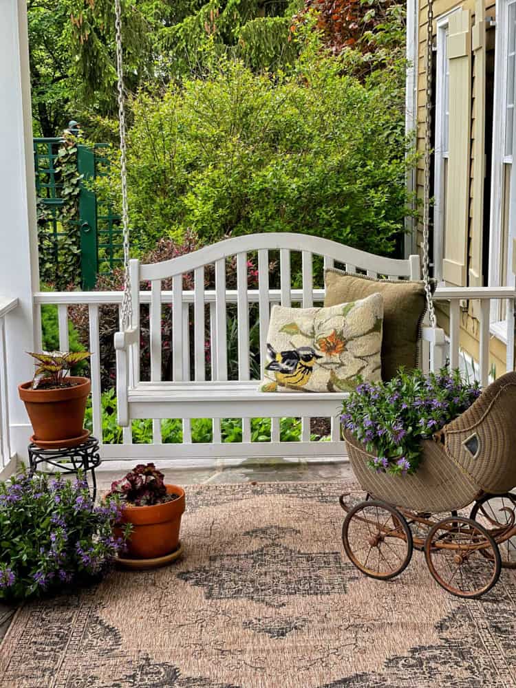 Vintage baby stroller is a great container for flowers. Antique planter.