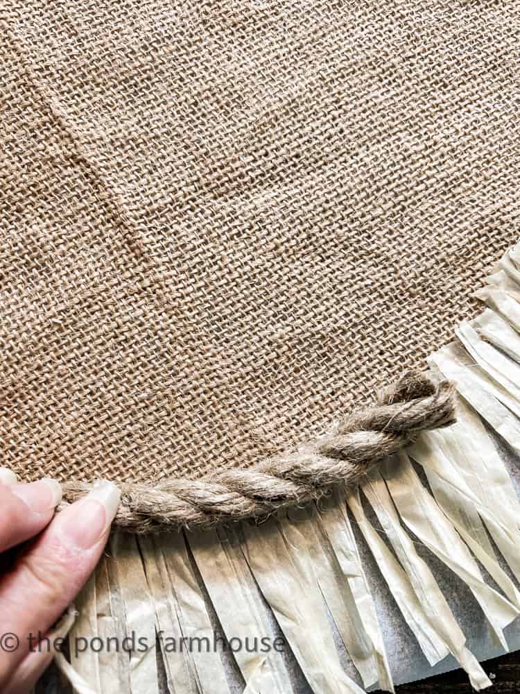 Using hot glue, add jute rope trim to round placemats, diy luau placemat, hawaiian placemat, 