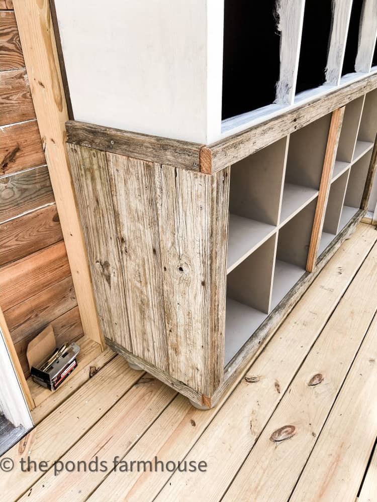 Add reclaimed wood to IKEA cabinet to make apothecary cabinet.