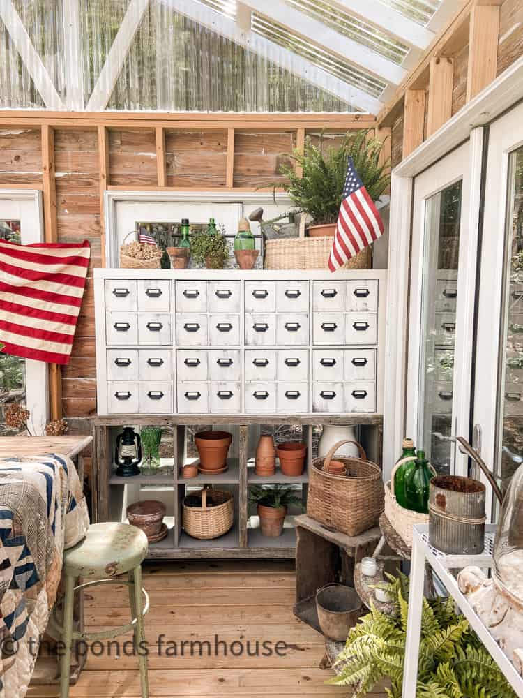 DIY Apothecary Cabinet in Greenhouse - with American Flags and other patriotic decor
