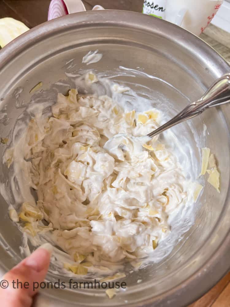 Mix together mayo, sour cream, garlic powder and chopped artichokes