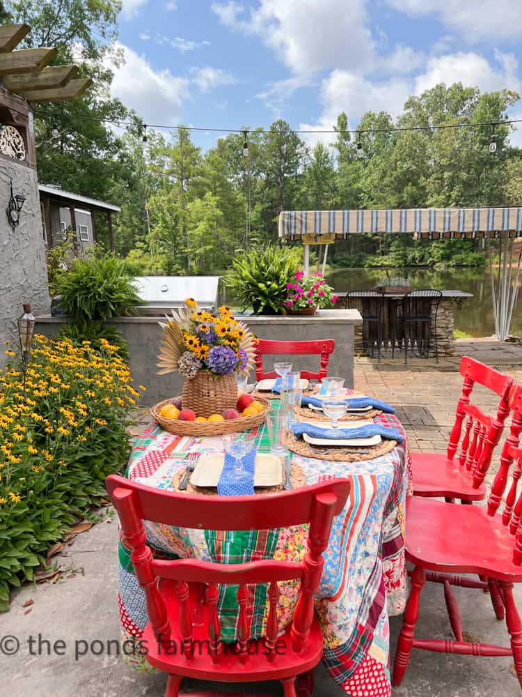 Outdoor BBQ Table Setting with Free Outdoor Centerpiece idea and fun thrifted dinnerware.  Quilt tablecloth 