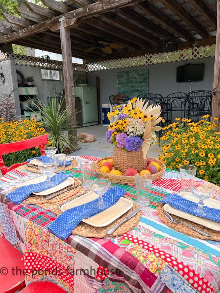 Outdoor BBQ Table Setting with thrifted table cloth, parfait glasses, &napkins and bamboo plates.  Free Centerpiece.  