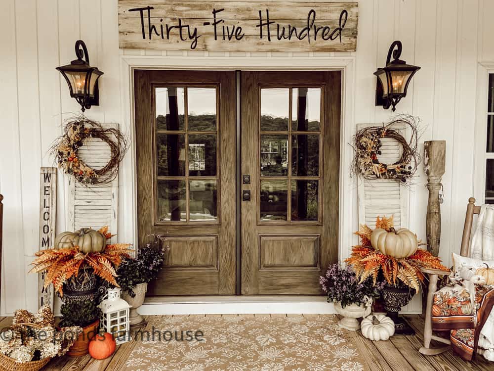 Double French Doors on Fall Front Porch Tour with White Shutters and Fall Wreaths and pumpkins on planters
