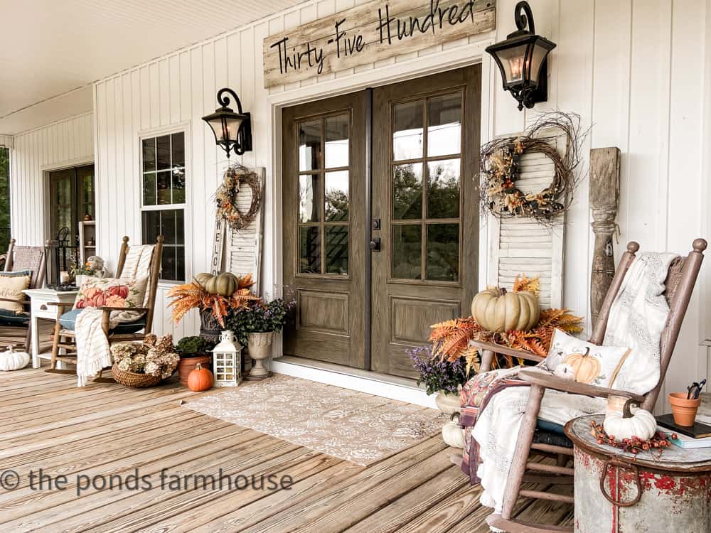 Farmhouse Front Porch Ideas for a large porch with french doors and shutters with grapevines wreaths. 