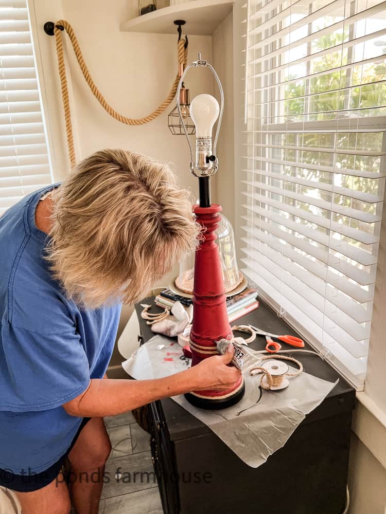 Add glue to attach jute rope to lamp base.  Coastal Cottage Beach Decor Ideas. 