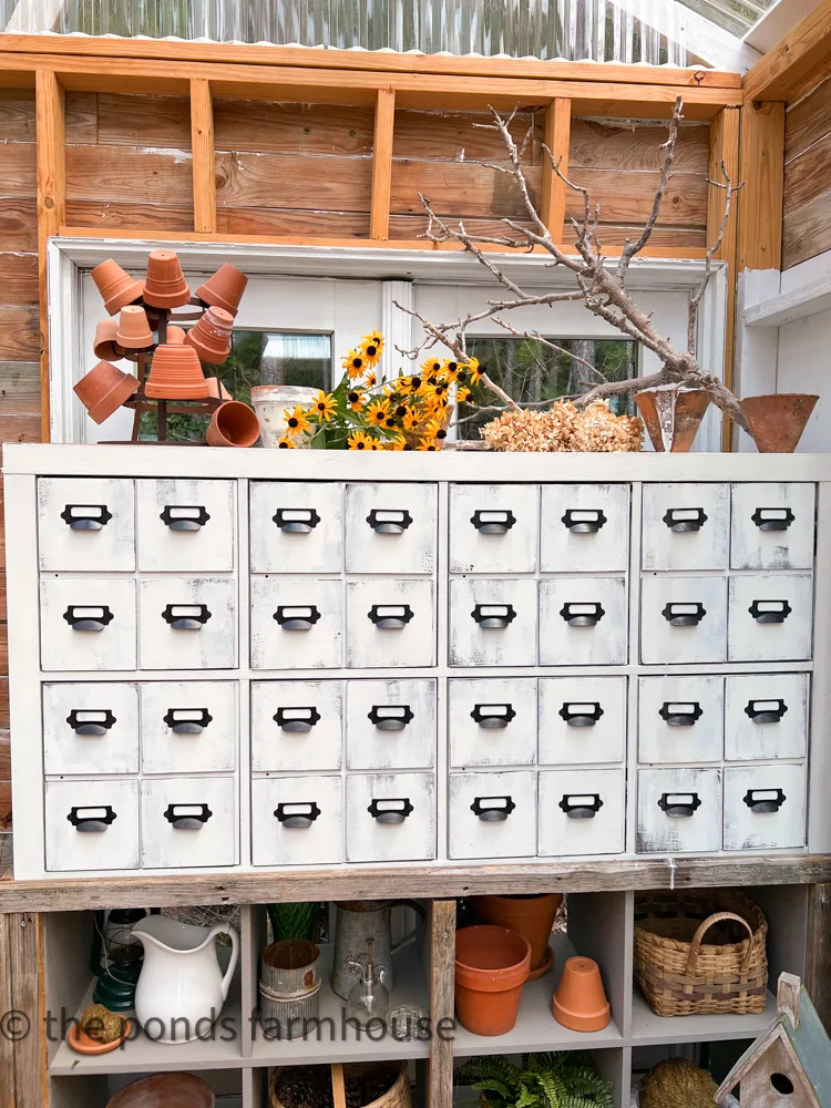 DIY Apothecary Cabinet IKEA Hack, with clay pots and black eyed susans. 
Greenhouse Decor.