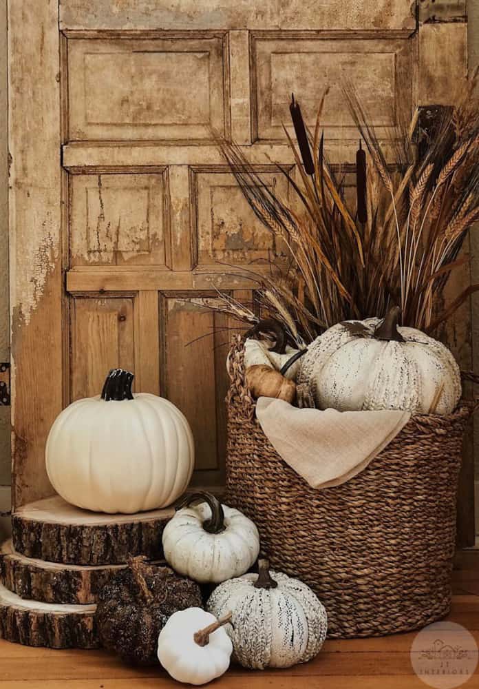 Pumpkins and basket with fall florals and wooden slices.  