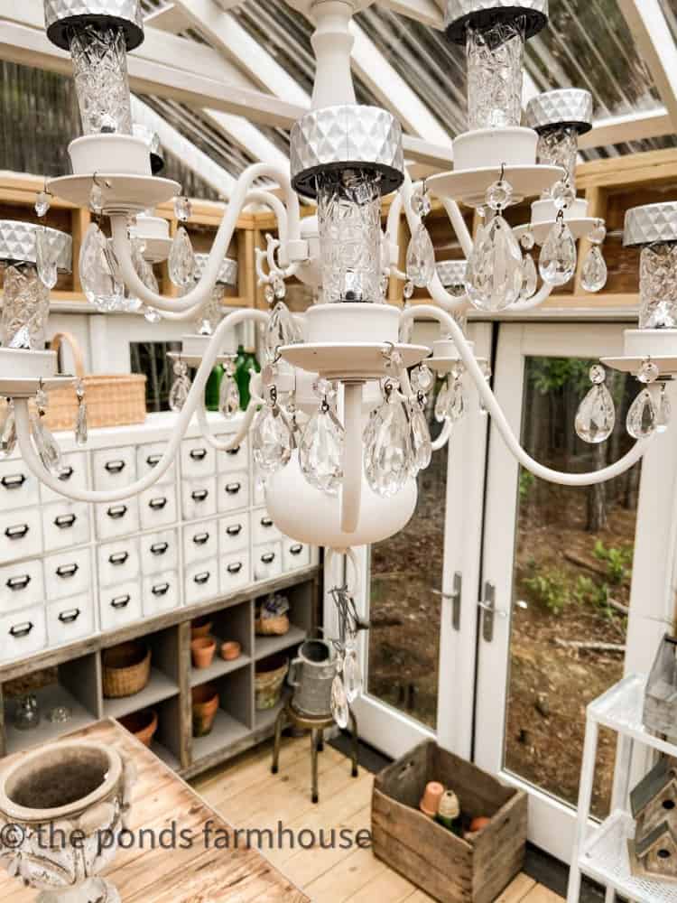 Dollar Tree Solar Lights allow the DIY Solar Light Chandelier to Glow at night in the greenhouse.