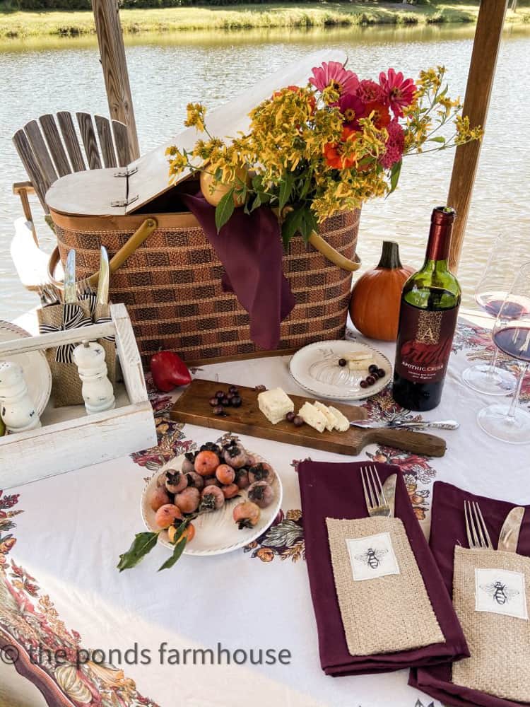 A vintage picnic basket table centerpiece idea for a fall outdoor table on the pier.