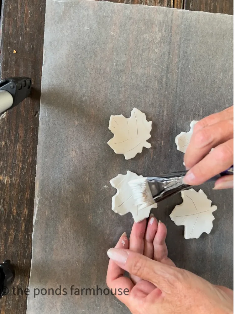 Air Dry Clay project with fall maple leaves painted white.  