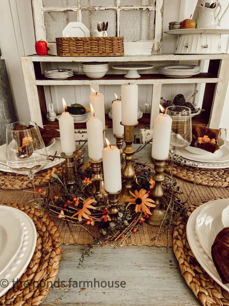 Gather a grouping of vintage brass candlesticks inside a fall wreath for a creative table centerpiece ideas.  