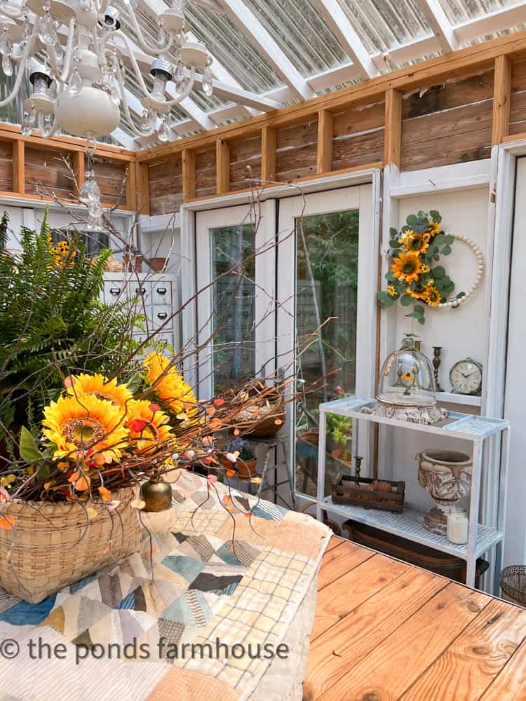 Sunflower Wreath and Cloche filled with a single bloom in DIY Greenhouse for Sunflower Season