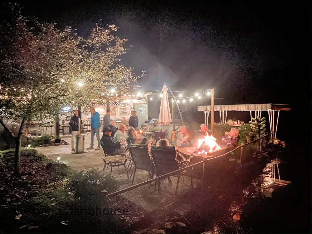 Outdoor party with friends. Fire pit. Outdoor lighting. Outdoor heaters. Outdoor entertaining by outdoor kitchen and fire pit.
