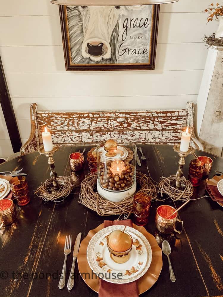 Hurricane lantern candle holder with acorns and grapevine wreath for Ideas for Thanksgiving Table decorations.  