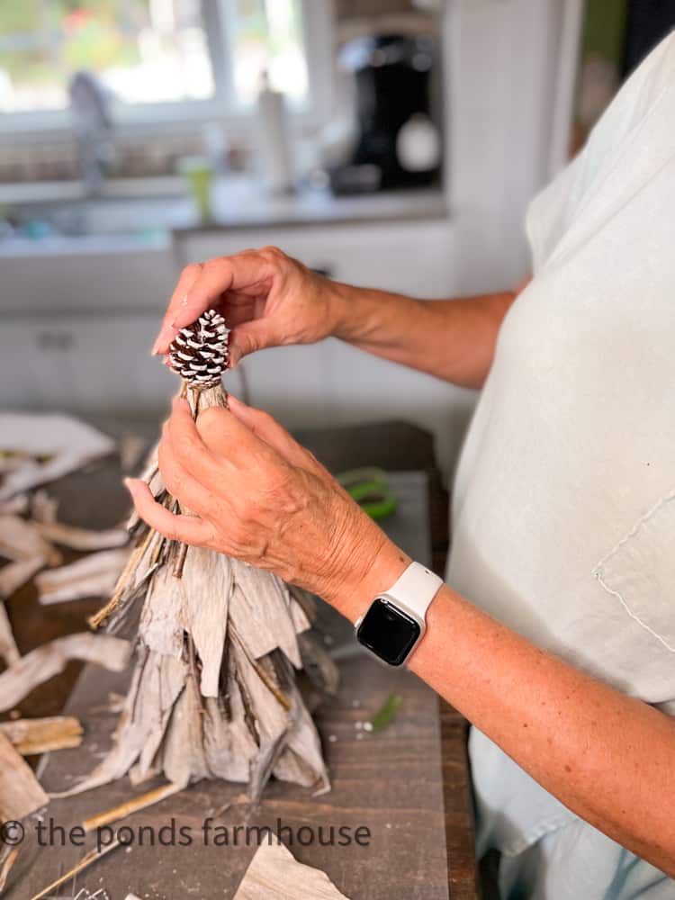 Attach a foraged pinecone to top of corn husk topiaries.  Modern Farmhouse Fall Decor.