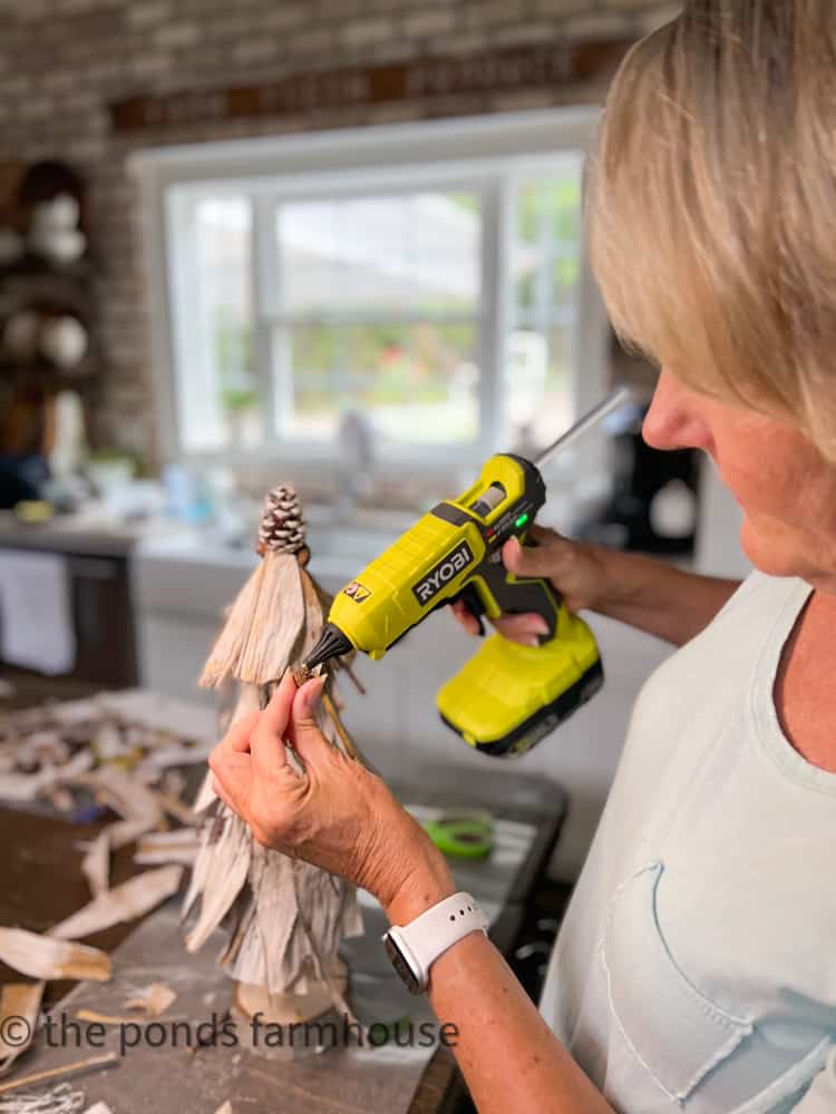 Hot glue foraged acorns to topiaries for fall decor and farmhouse style decorating