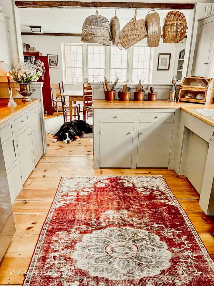 Basket hanging in a cottage kitchen for vintage charm.