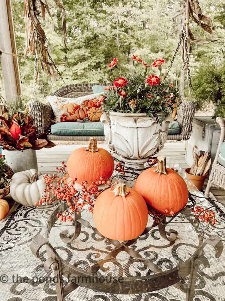 A trio of real pumpkins and an urn filled with marigolds make a great centerpiece for the coffee table.