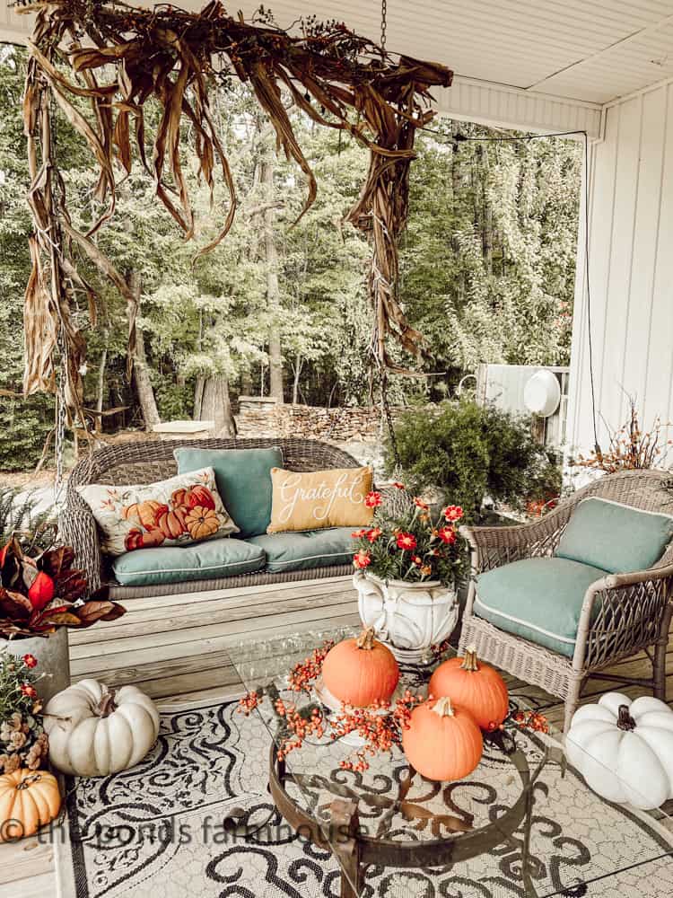 Swing draped in DIY Corn Stalks Garland for fall decor.