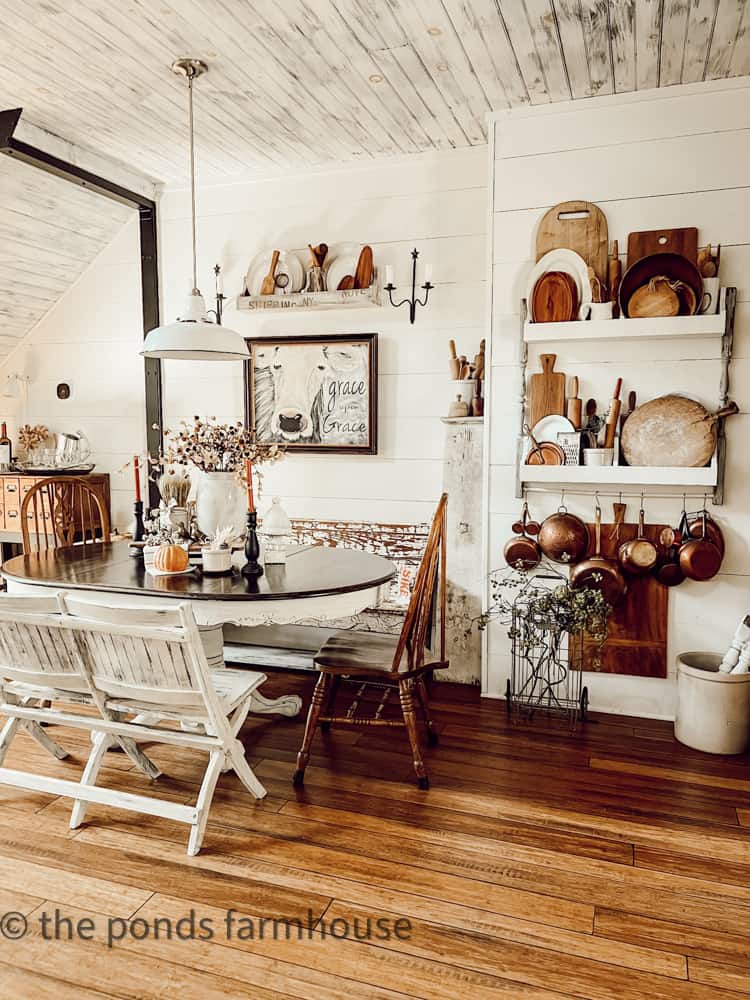 Dining area for fall home tour with vintage copper and bread boards on DIY plate rack.  
