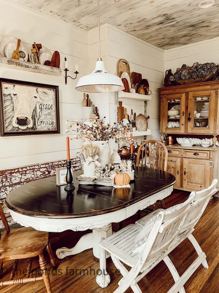 Dining table decorated for fall home tour with vintage and thrifted accessories and tableware.  