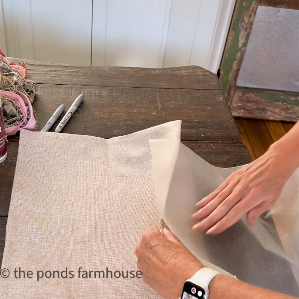 Protect between pillow cover fabric with a sheet of wax paper.  