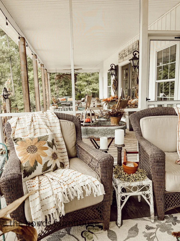 Cozy seating with throw pillow and blanket over looking the adjacent front porch.