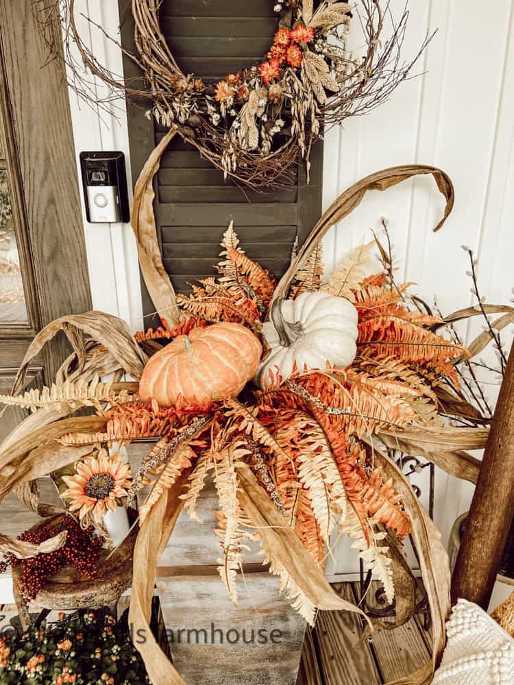 Dupe planter with fall pumpkins and faux Autumn plants.