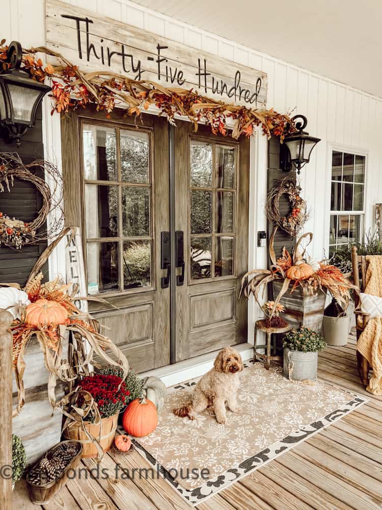 Large Farmhouse Porch Ideas for Fall and Autumn Cozy Decorating.  Front Doors with garland and planters filled with pumpkins