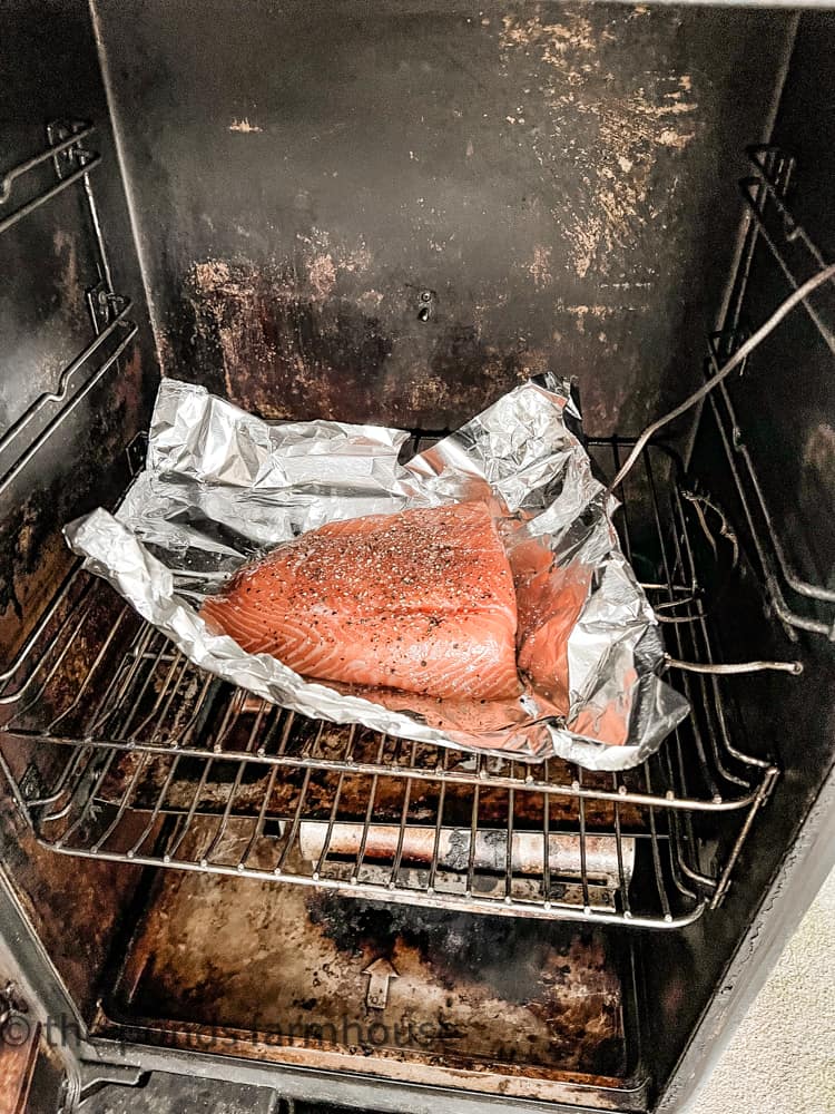 Place salmon on tin foil inside electric smoker