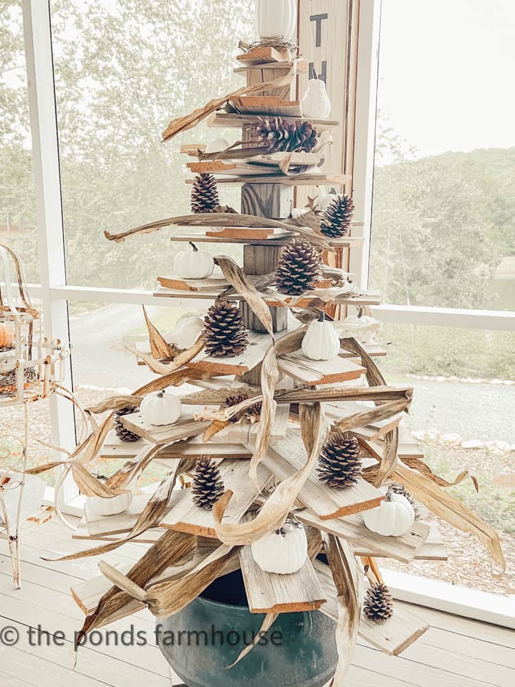 corn husks on shiplap tree decorated for Autumn