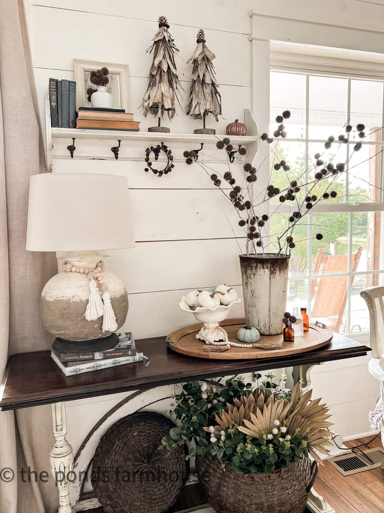 Cottage Style Entryway table with fall pumpkins, corn stalk topiaries, sweet gum ball stems all cheap foraged DIY Projects