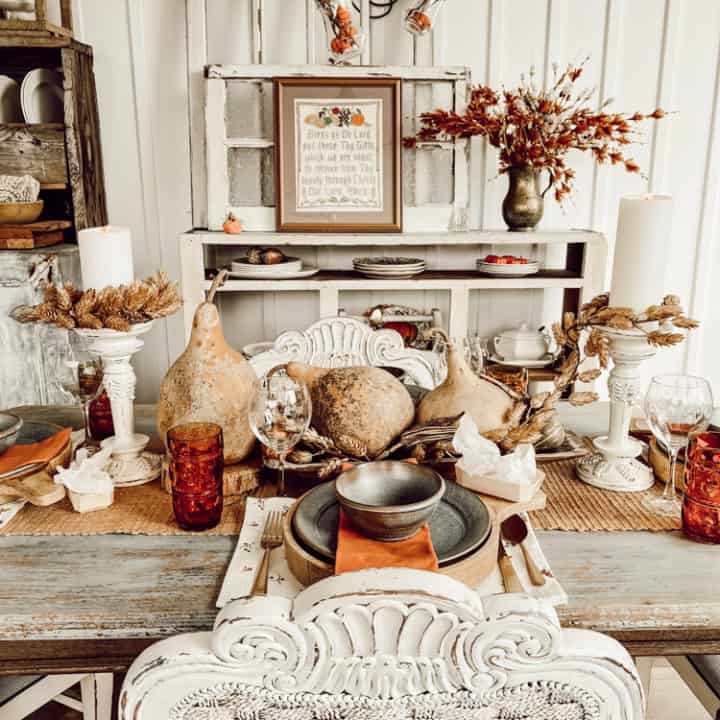 porch table decorated with gourd centerpiece on fall tablescape