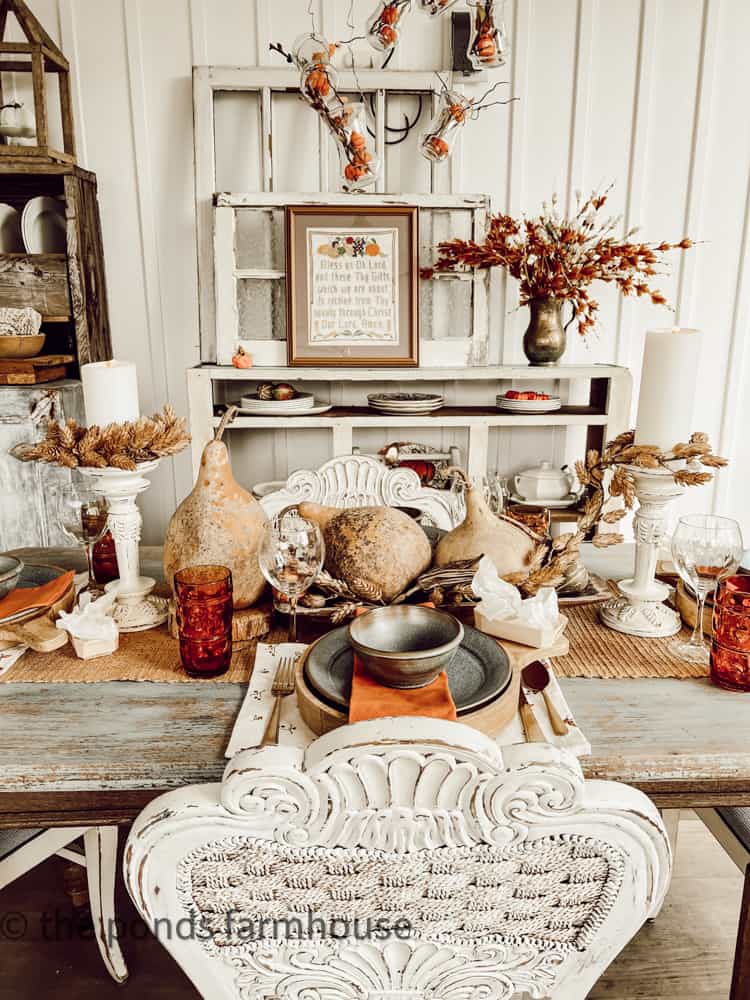 Fall Table decor ideas on screen porch with gourds and dried okra pods.  