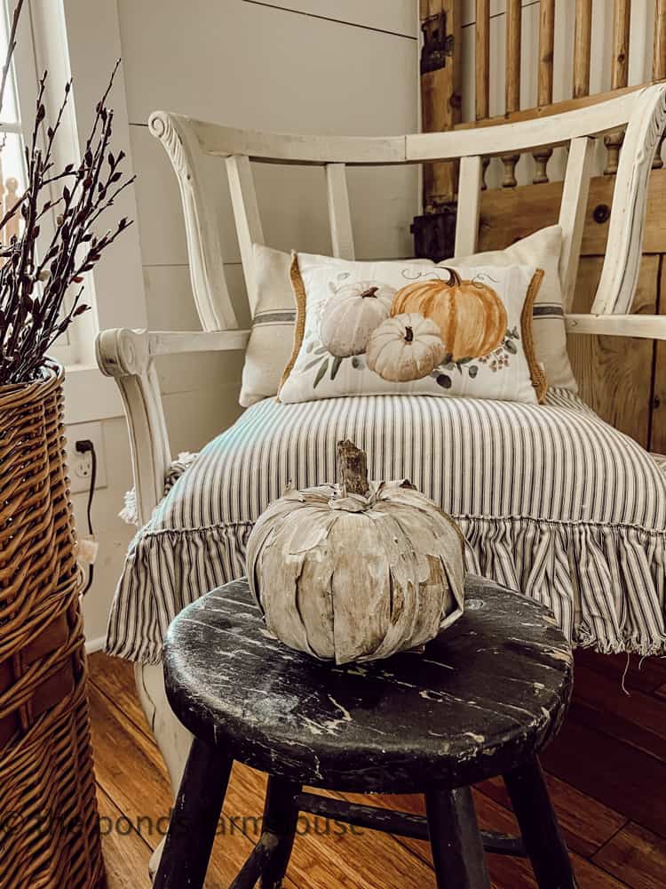 Rustic Fall DIY Pumpkin on black stool with deconstructed chair.