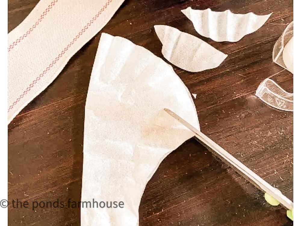 Cut coffee filters to make the shaped like holly leaves