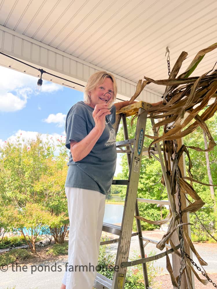 Hang corn stalks decor for autumn front porch decor and cottage style outdoor decorating for fall