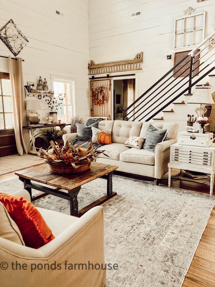 Industrial farmhouse living area in open concept modern farmhouse decorated for fall home tour.