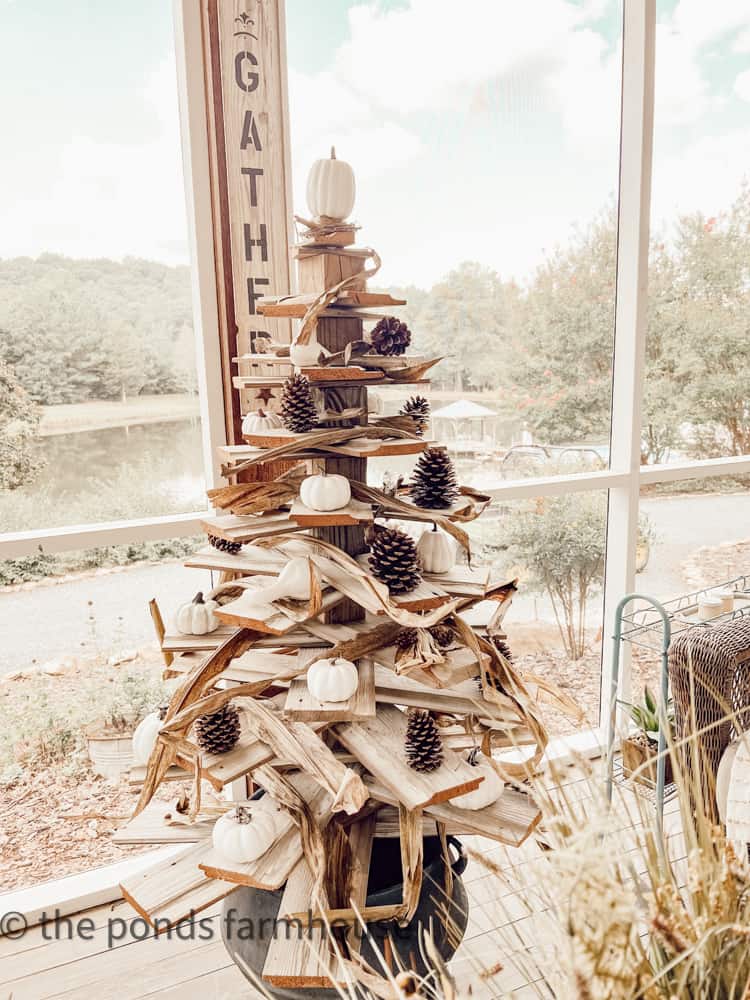 DIY Shiplap Tree decorated with corn stalk decorations for fall screened-in porch decorating.  