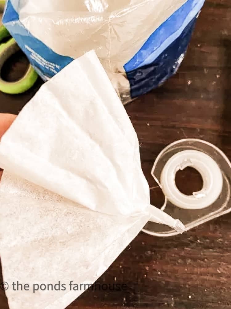 add tape to hold the flowers made from coffee filters