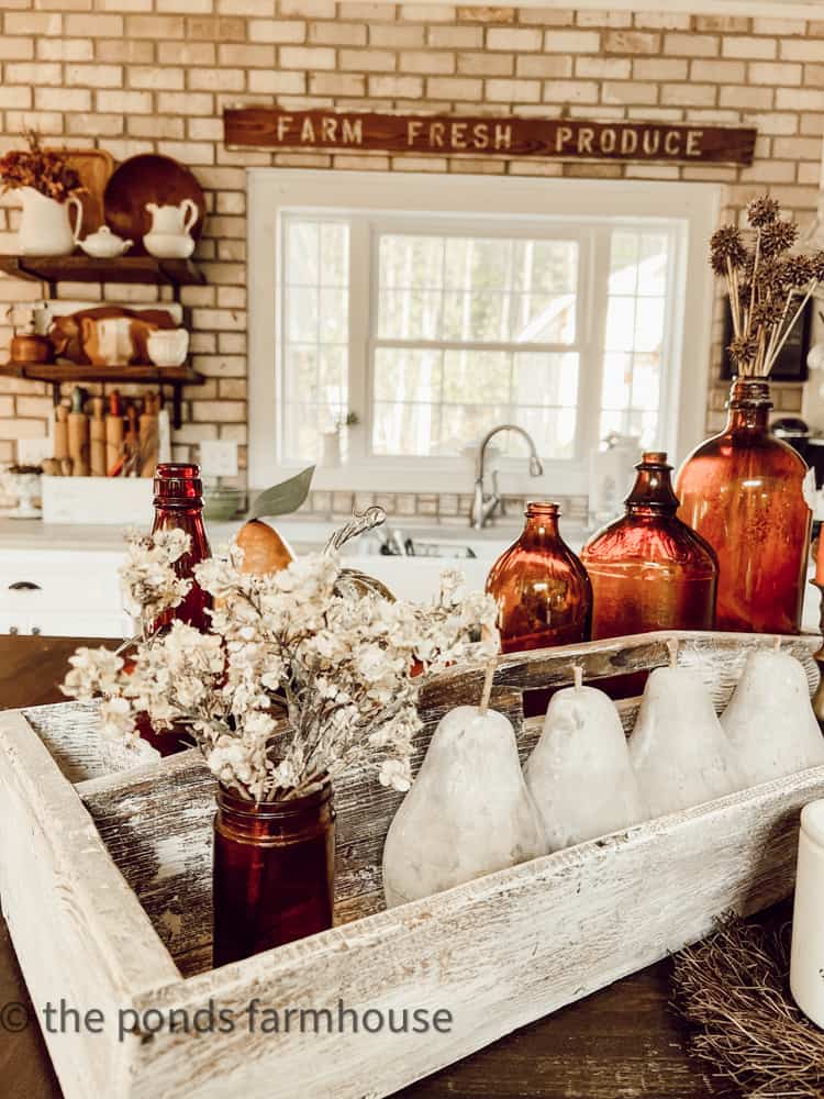 Vintage tool box filled with amber bottles for fall vignette.  Vintage Home Tour