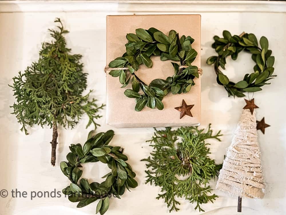 Christmas Boxwood Ornaments and Holiday Package Toppers made with fresh greenery.