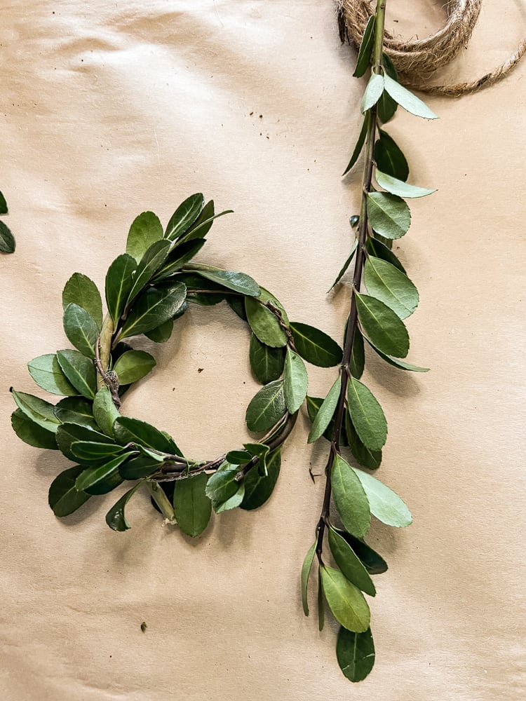 Twist Christmas Boxwood Around the floral wire twice for a full wreath